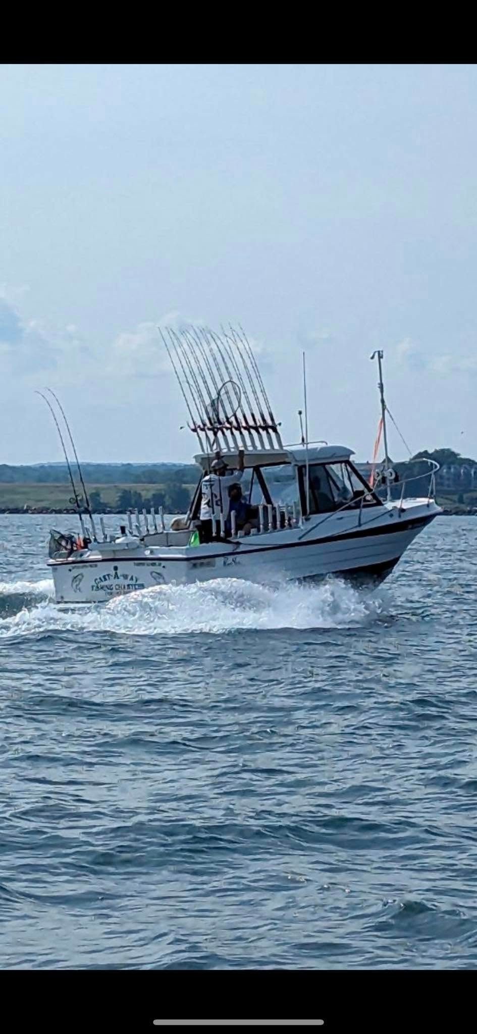 A boat is floating on top of a body of water.