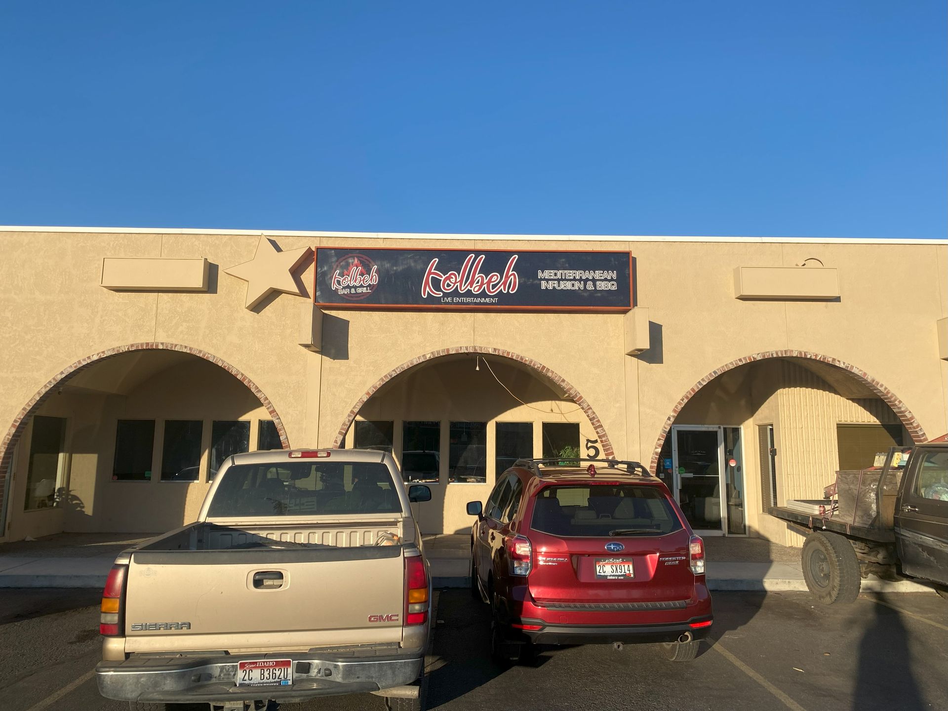 A few cars are parked in front of a building