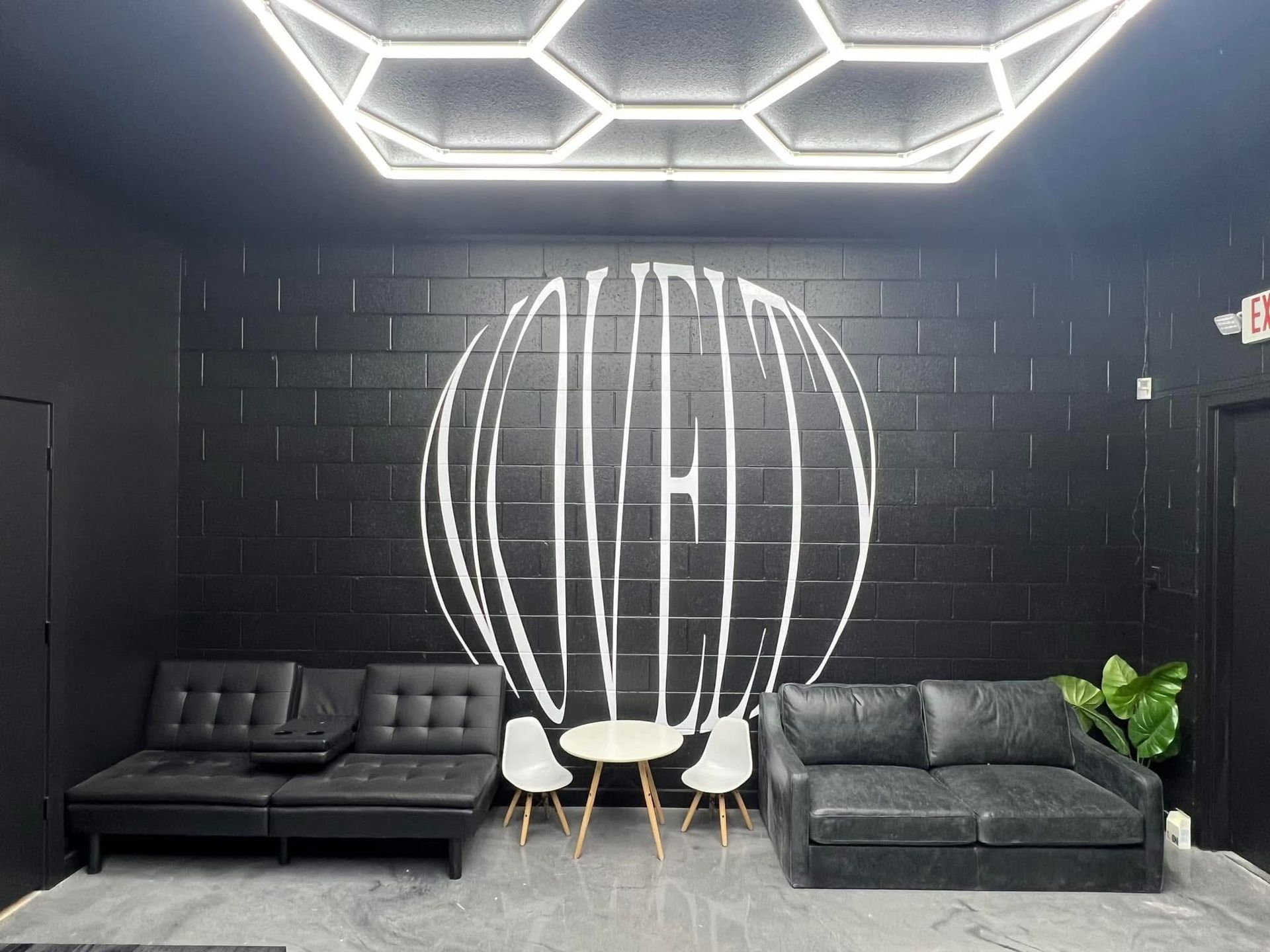 A living room with a couch , chairs and a table.