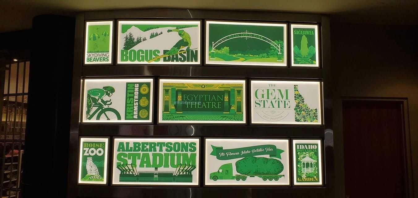 A wall with a bunch of green posters on it