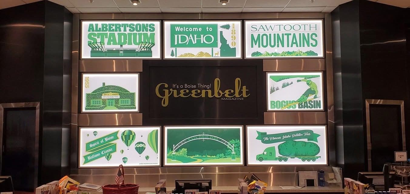 A wall with a lot of green signs on it