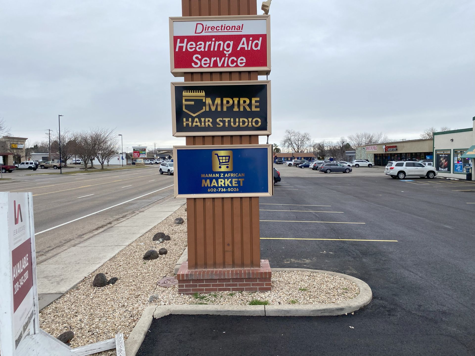 A sign for hearing aid service and empire hair studio