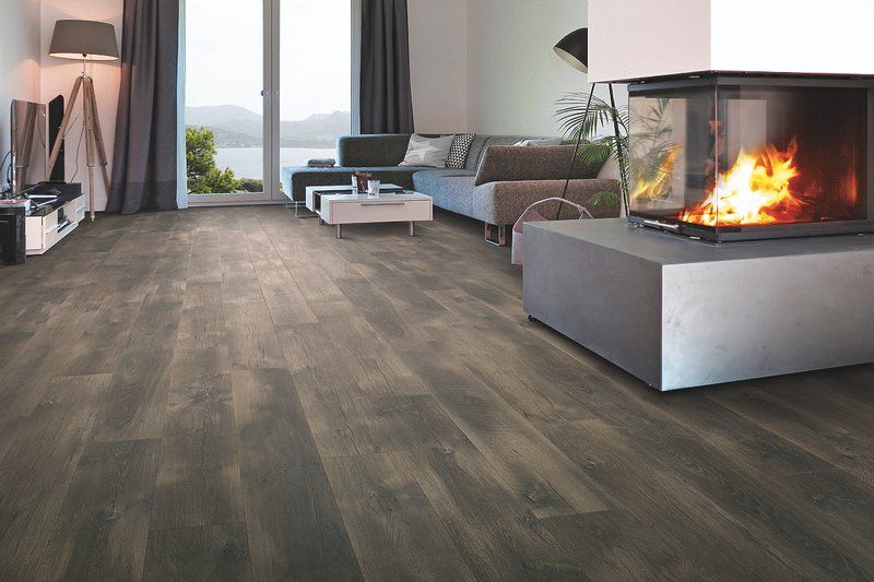 A living room with hardwood floors and a fireplace.