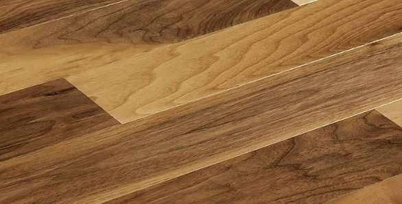 A close up of a wooden floor with a diagonal pattern.