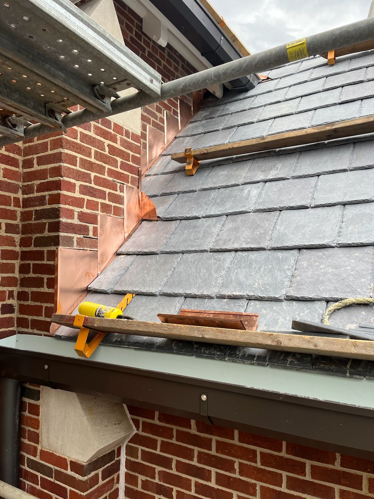 a brick building with a roof that is being installed .