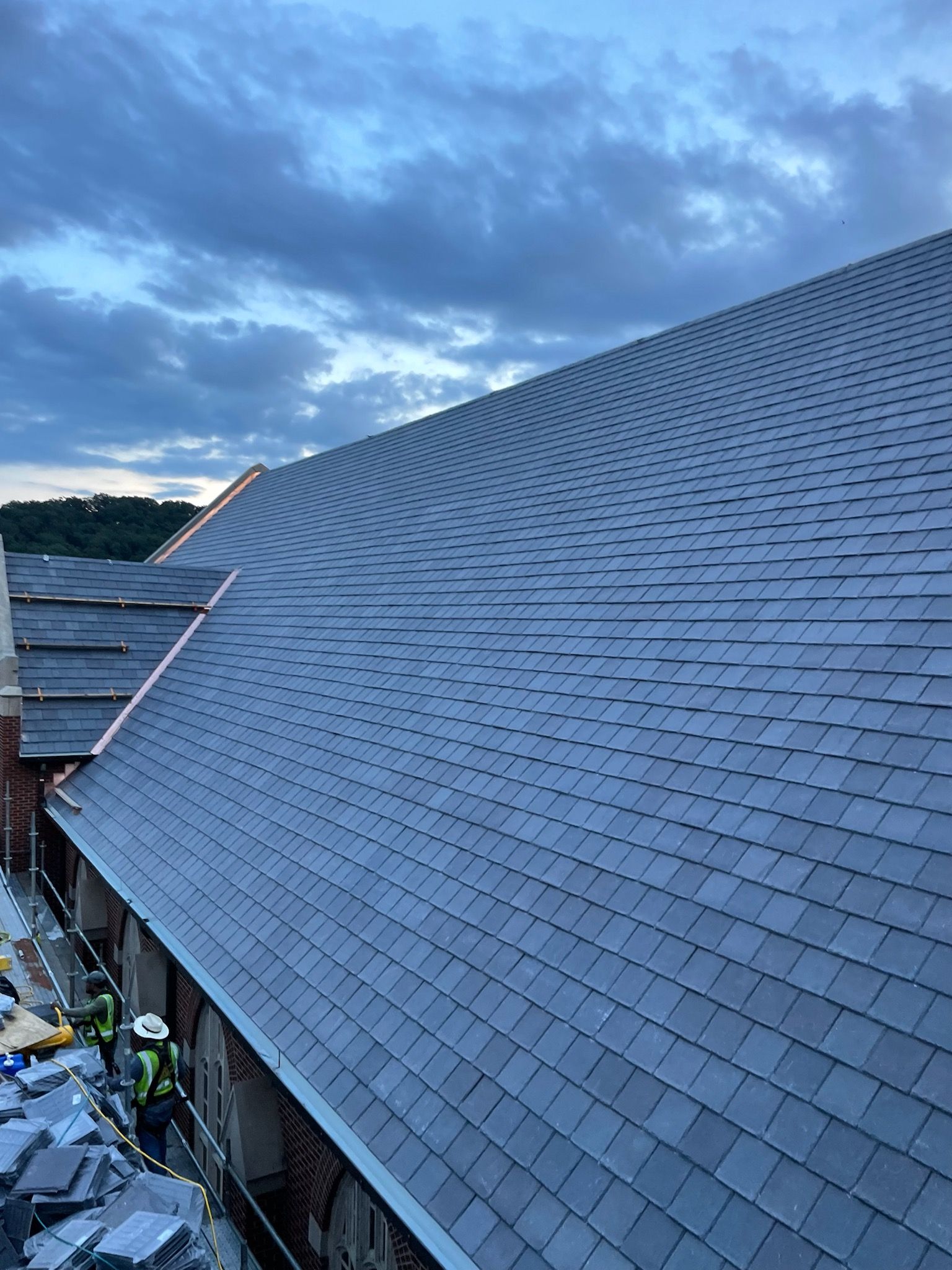 a roof with a lot of tiles on it and a blue sky in the background .