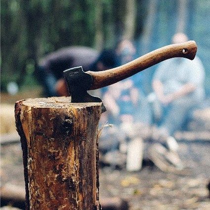 An ax on a stump of wood