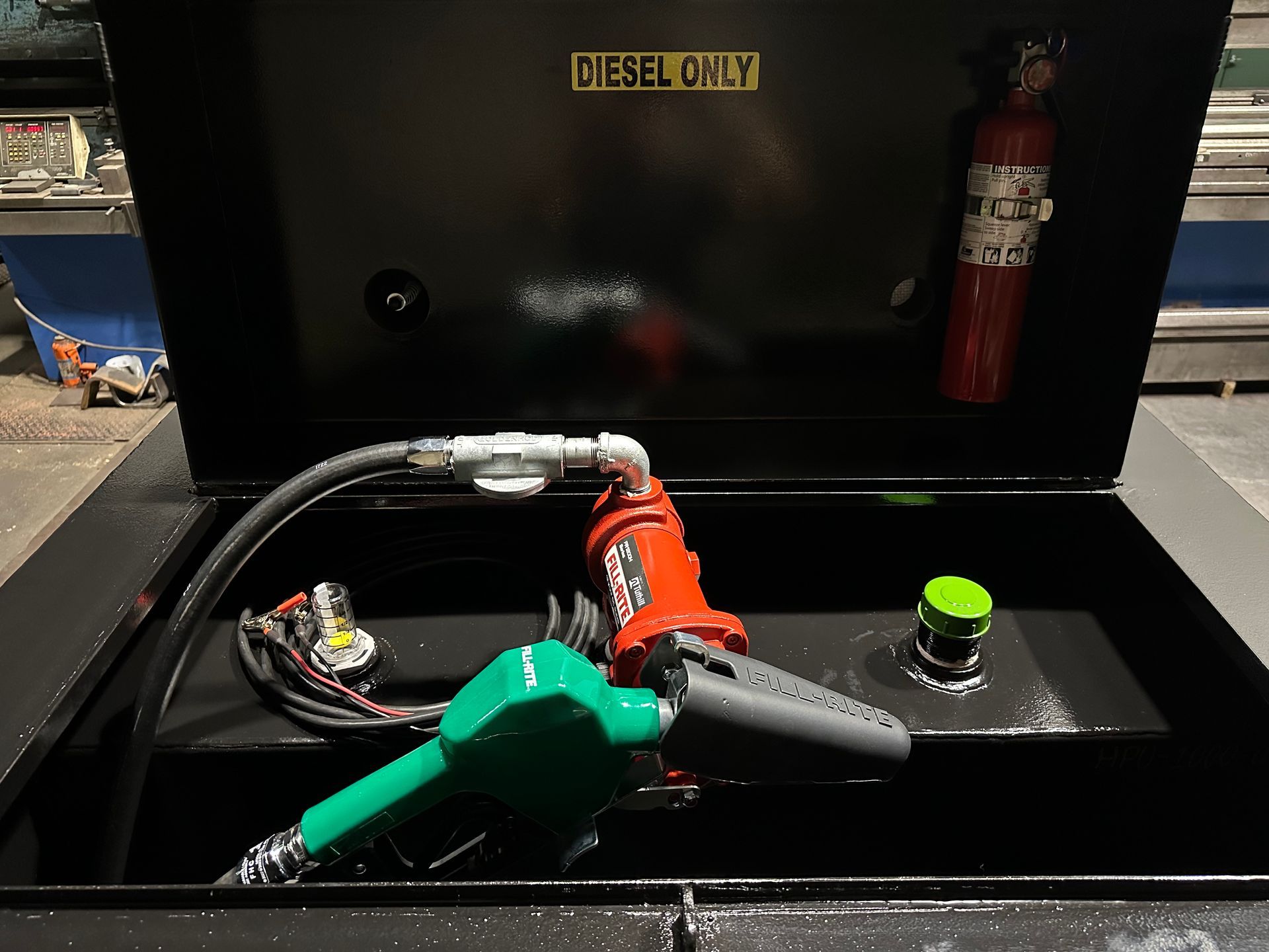 A gas pump and a fire extinguisher are in a container that says kingstown