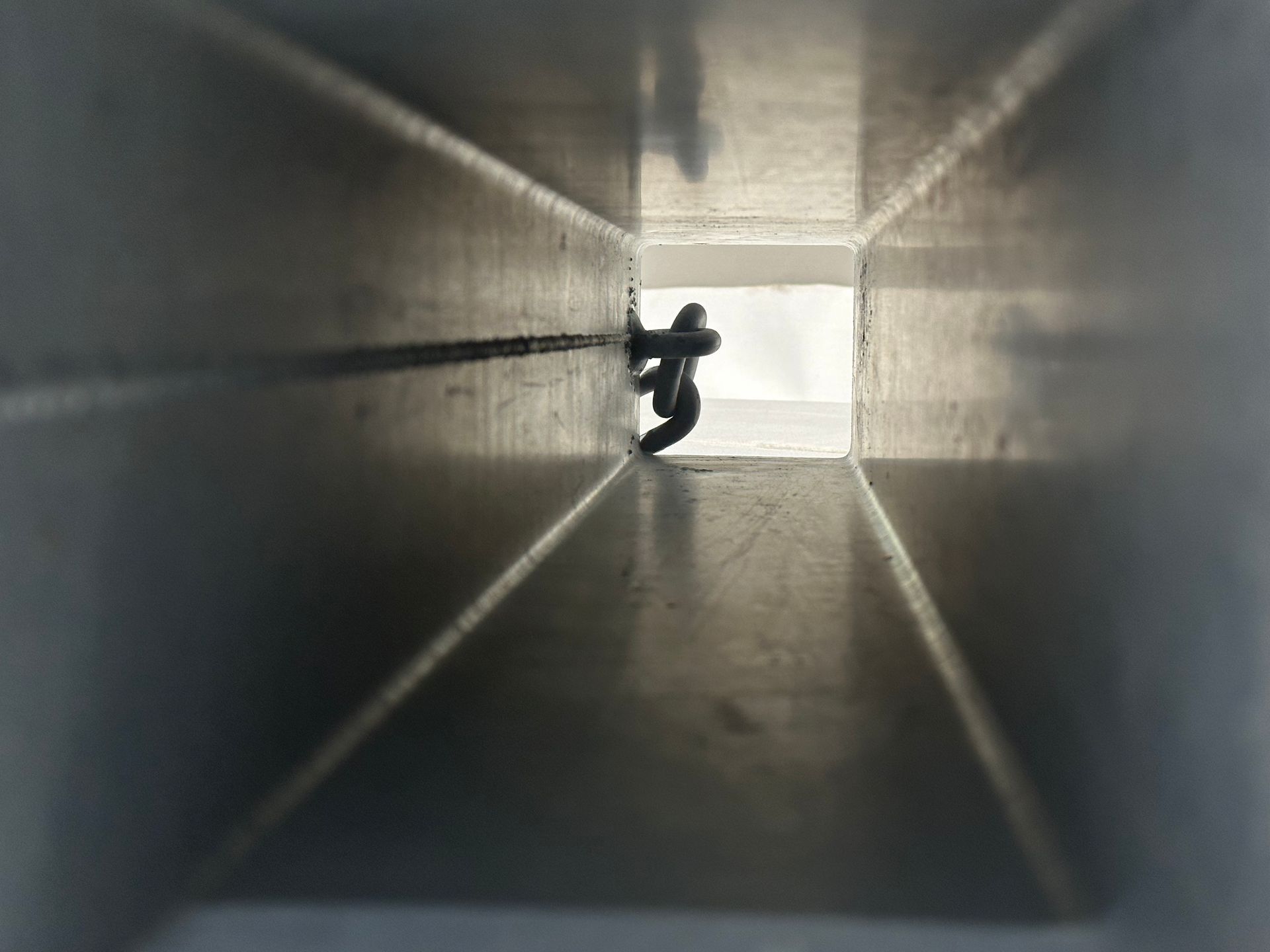 A person is standing in the middle of a narrow tunnel.