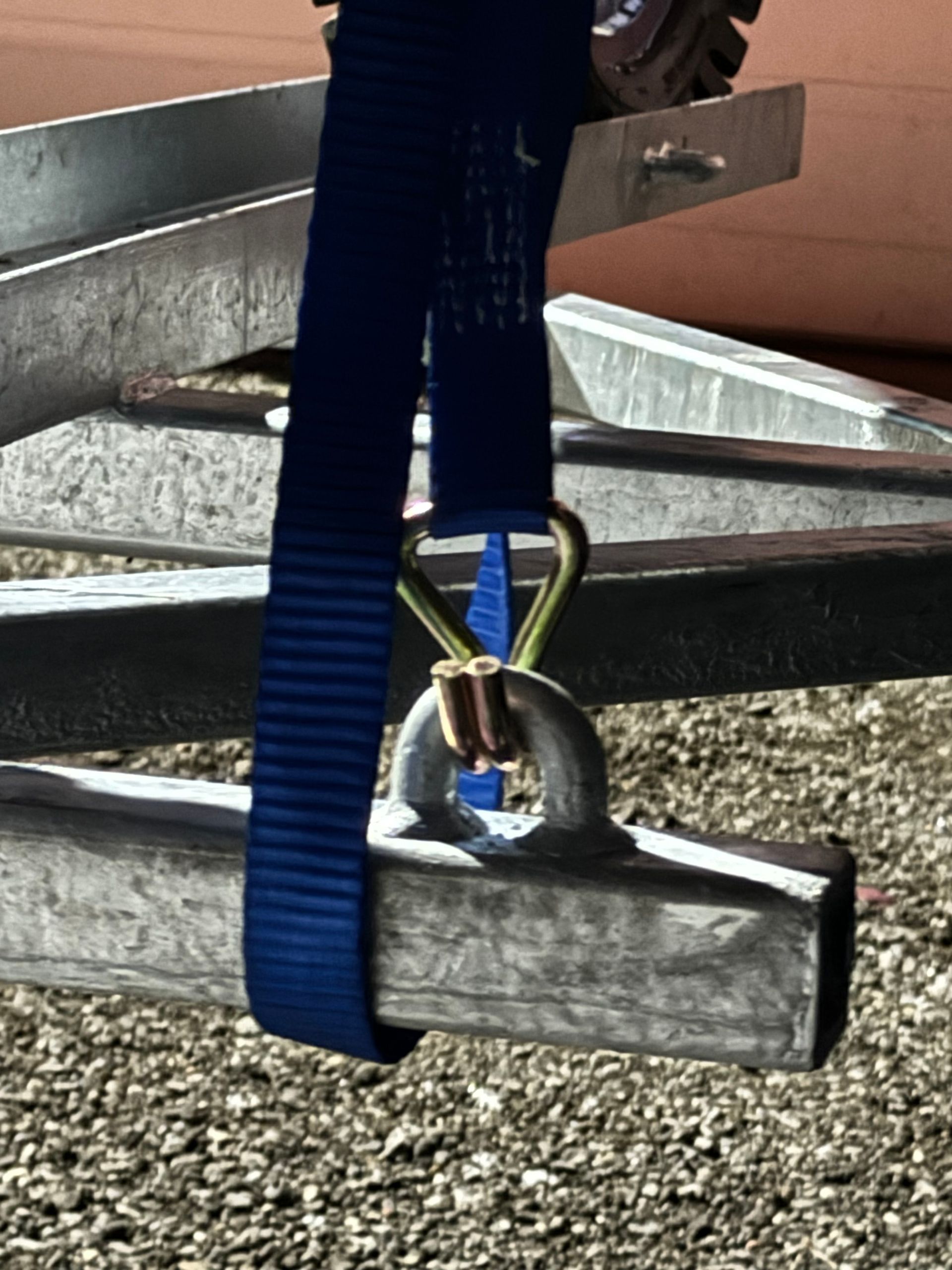 A blue strap is attached to a metal bar