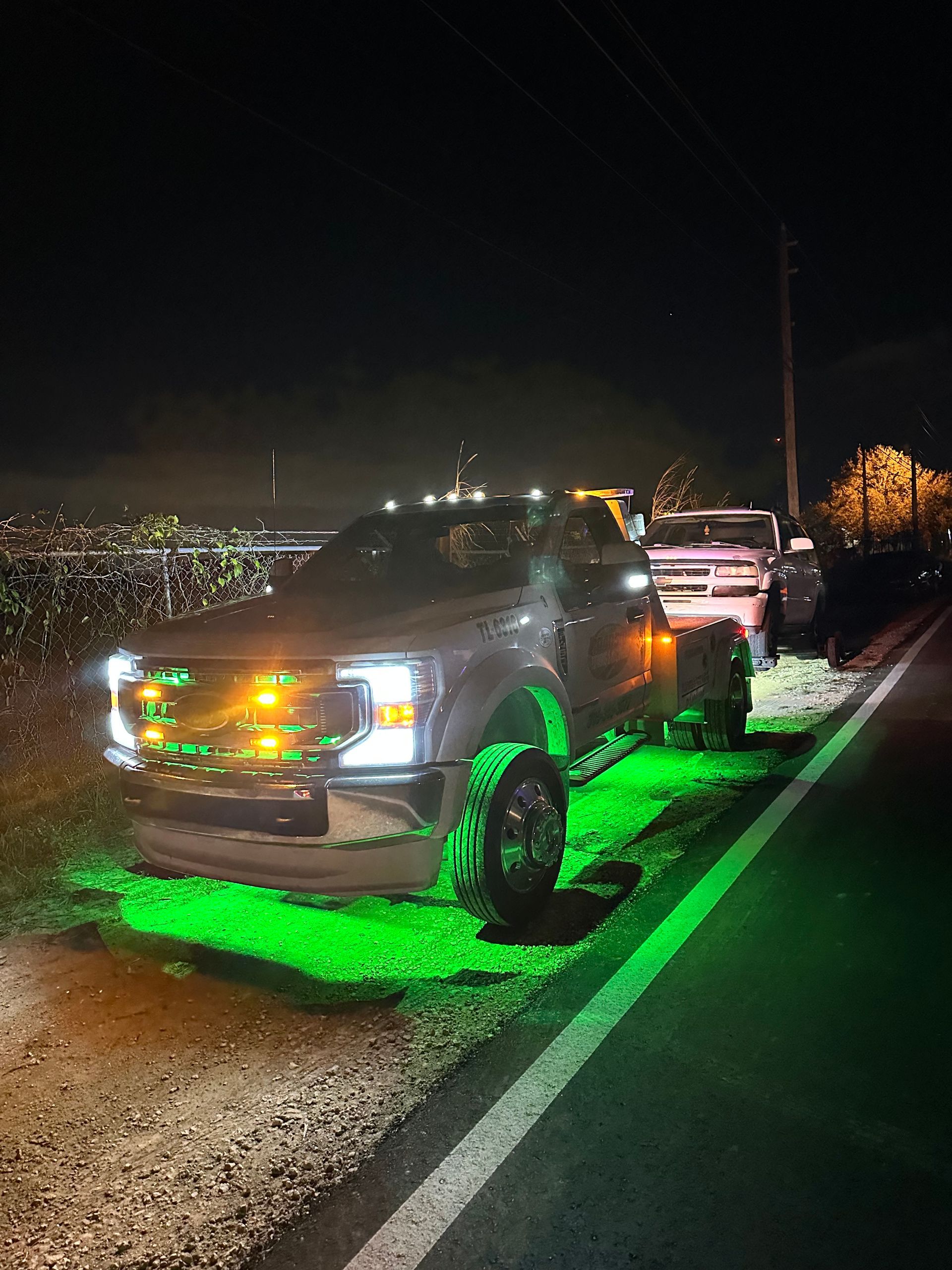 Emergency roadside assistance in Miami-Dade – Roadside Towing and Recovery truck with green underglow lighting providing night-time support.