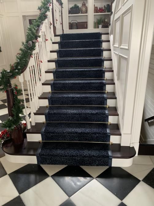 Worker using a cutter to carefully install new carpet flooring in a room, ensuring precise measurements and smooth placement.