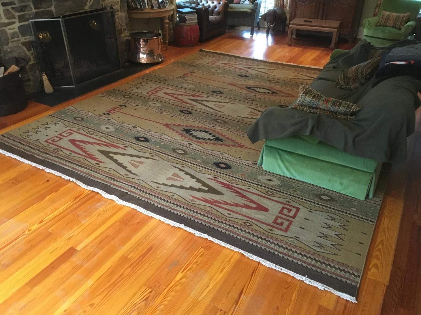 Worker using a cutter to carefully install new carpet flooring in a room, ensuring precise measurements and smooth placement.