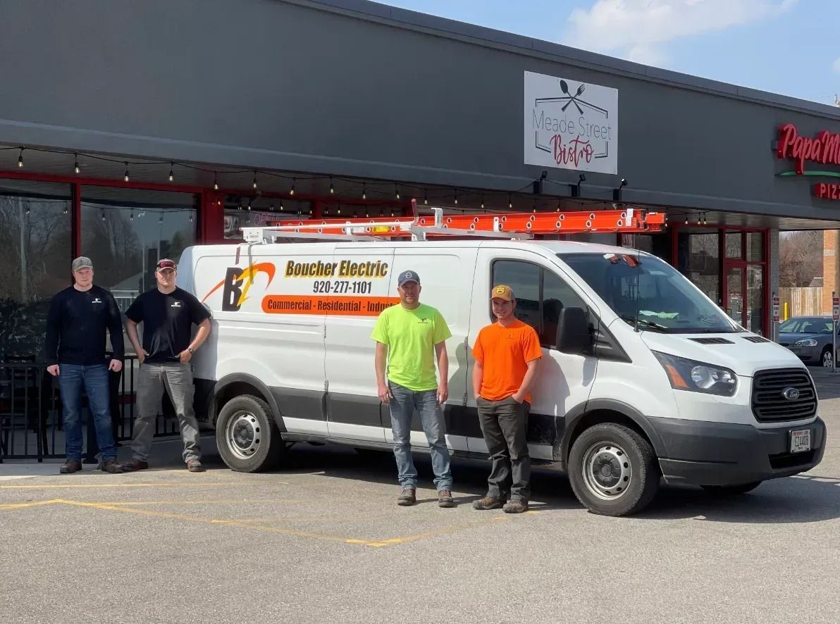 A spacious, empty industrial warehouse with a high, exposed truss ceiling, polished concrete floor, and black steel beams.
