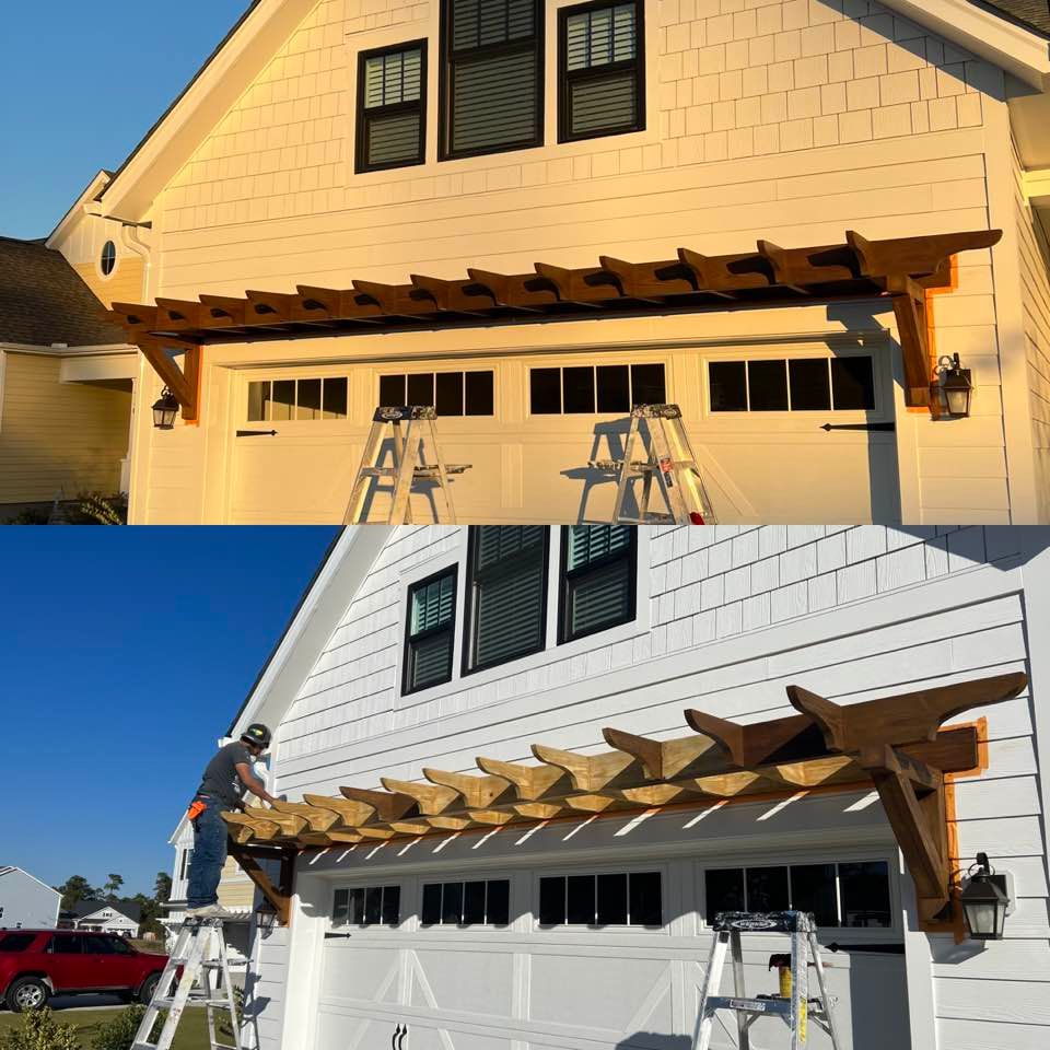 A white house with a wooden pergola over the garage door