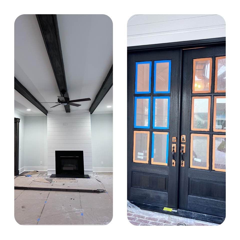 A living room with a fireplace and a black door.
