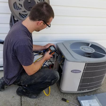 Mechanic working on air conditioning unit