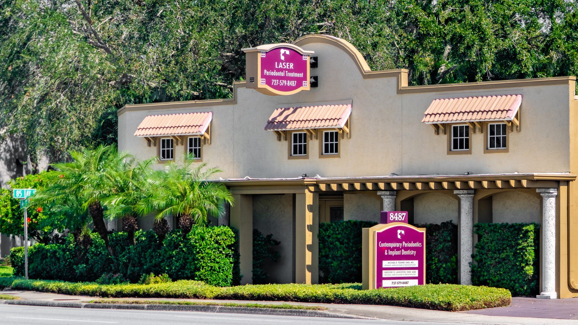 A large building with a purple sign on the front of it