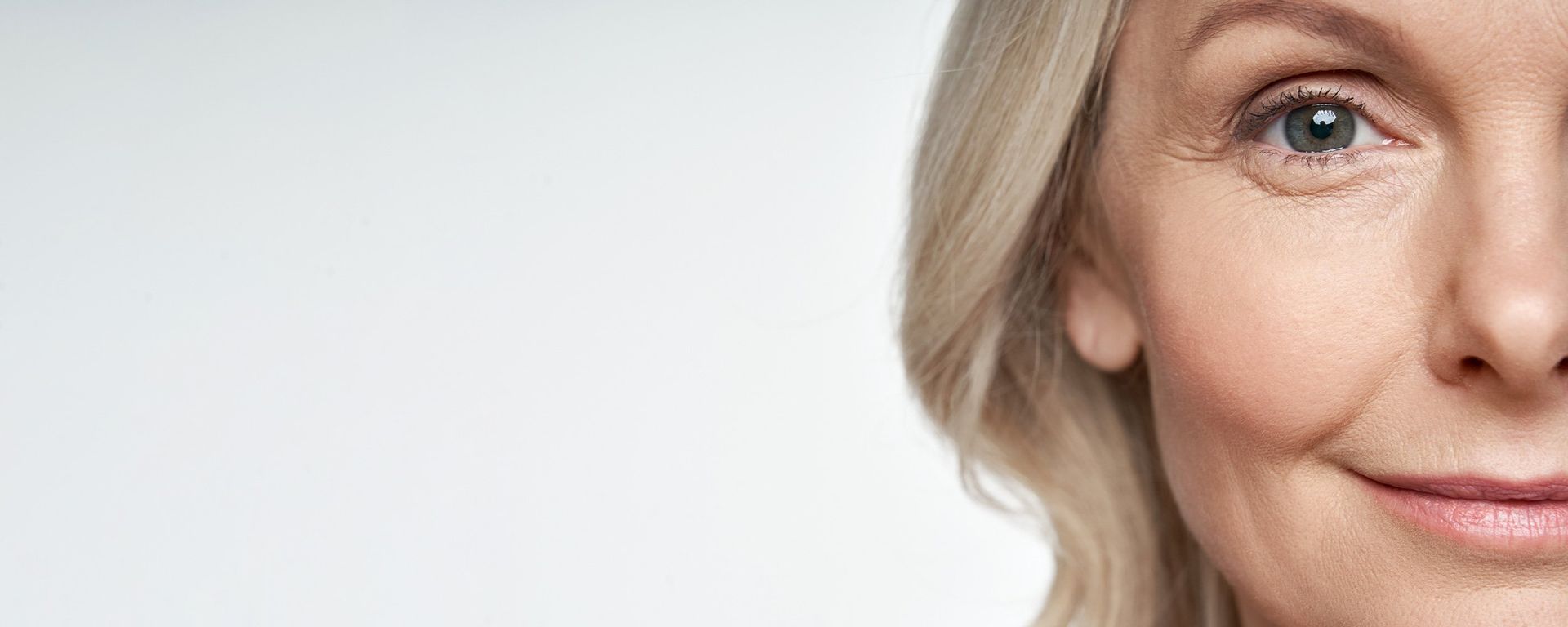 A close up of a woman 's face with a white background.