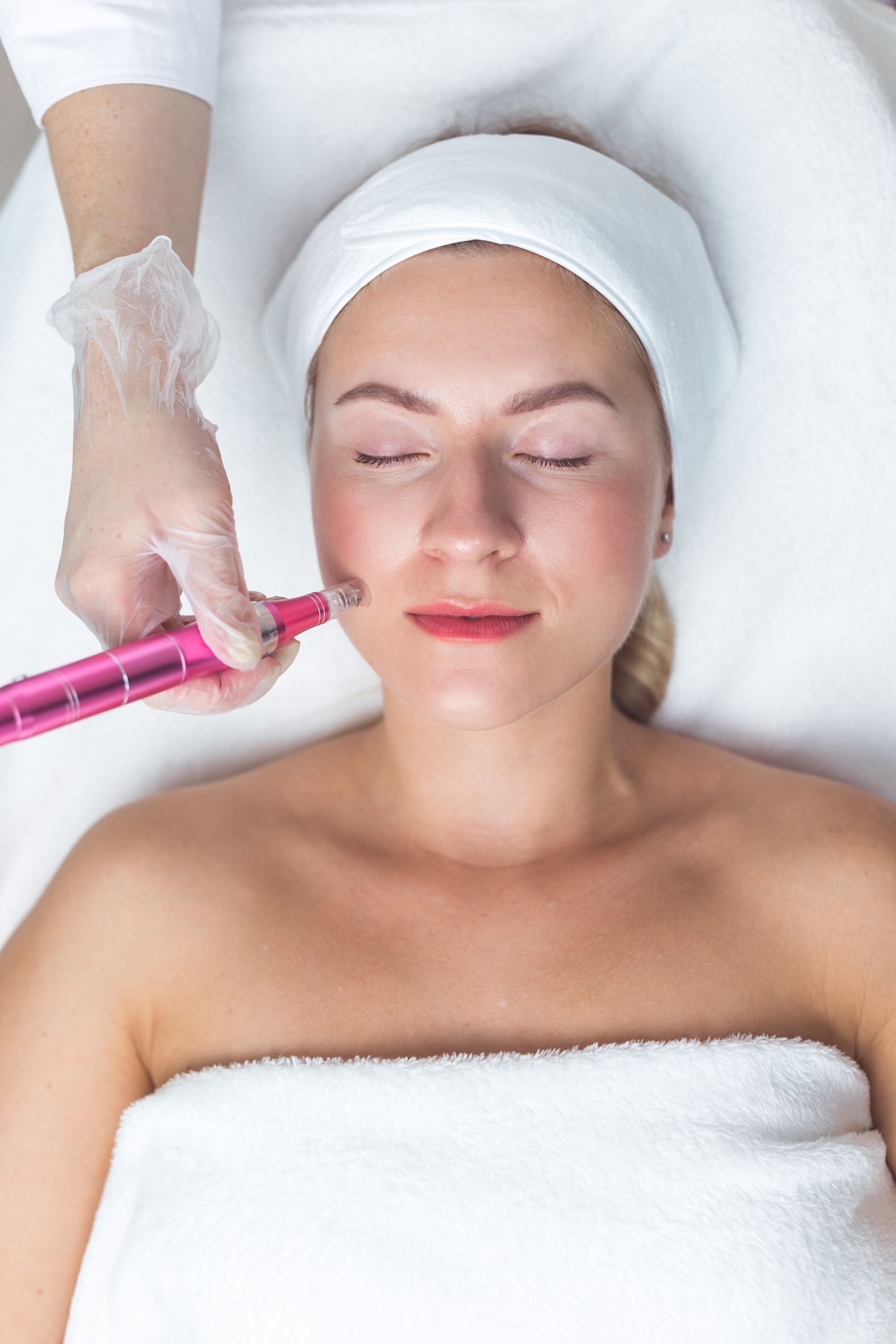 A woman is getting a facial treatment in a beauty salon.