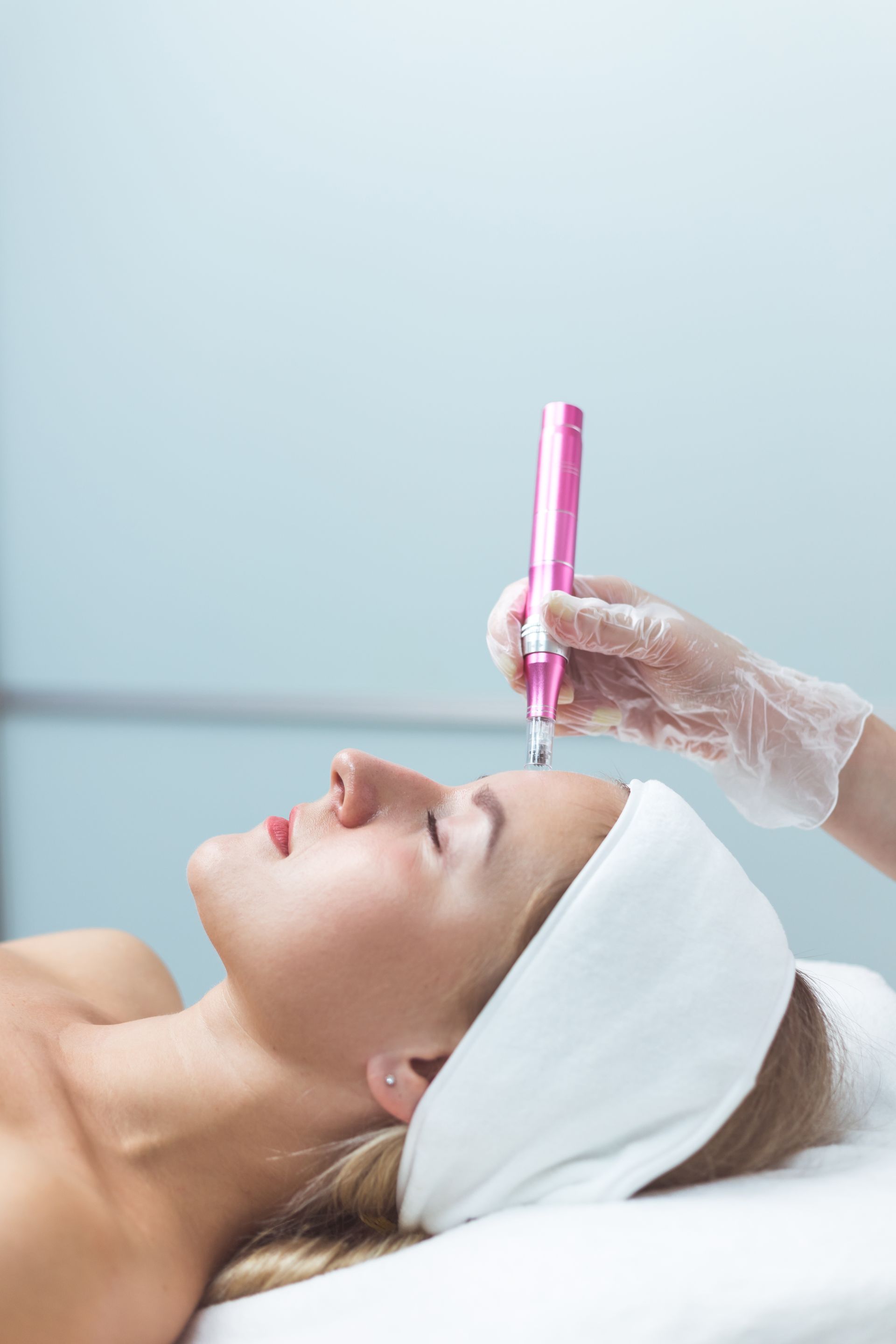 A woman is getting a facial treatment at a beauty salon.