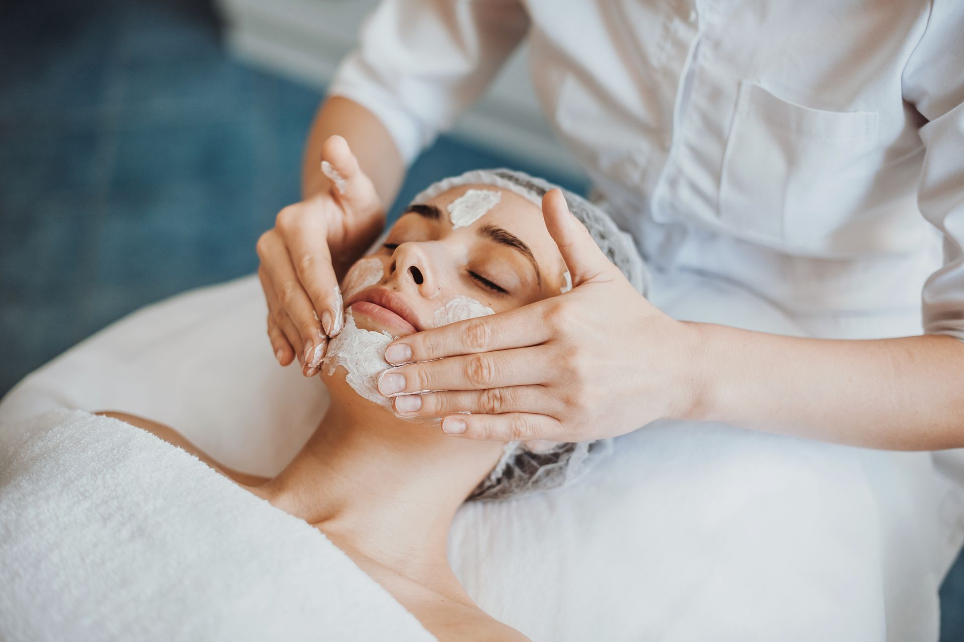 A woman is getting a facial treatment at a spa.