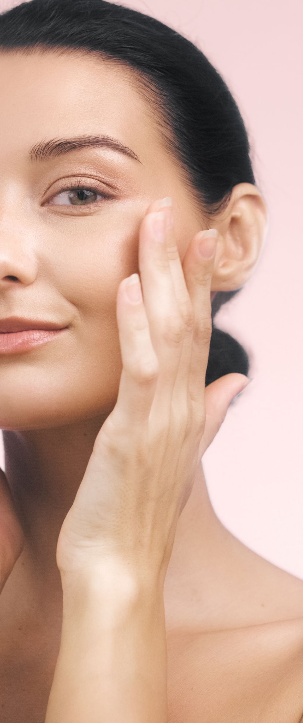 A woman is getting a facial massage at a spa.