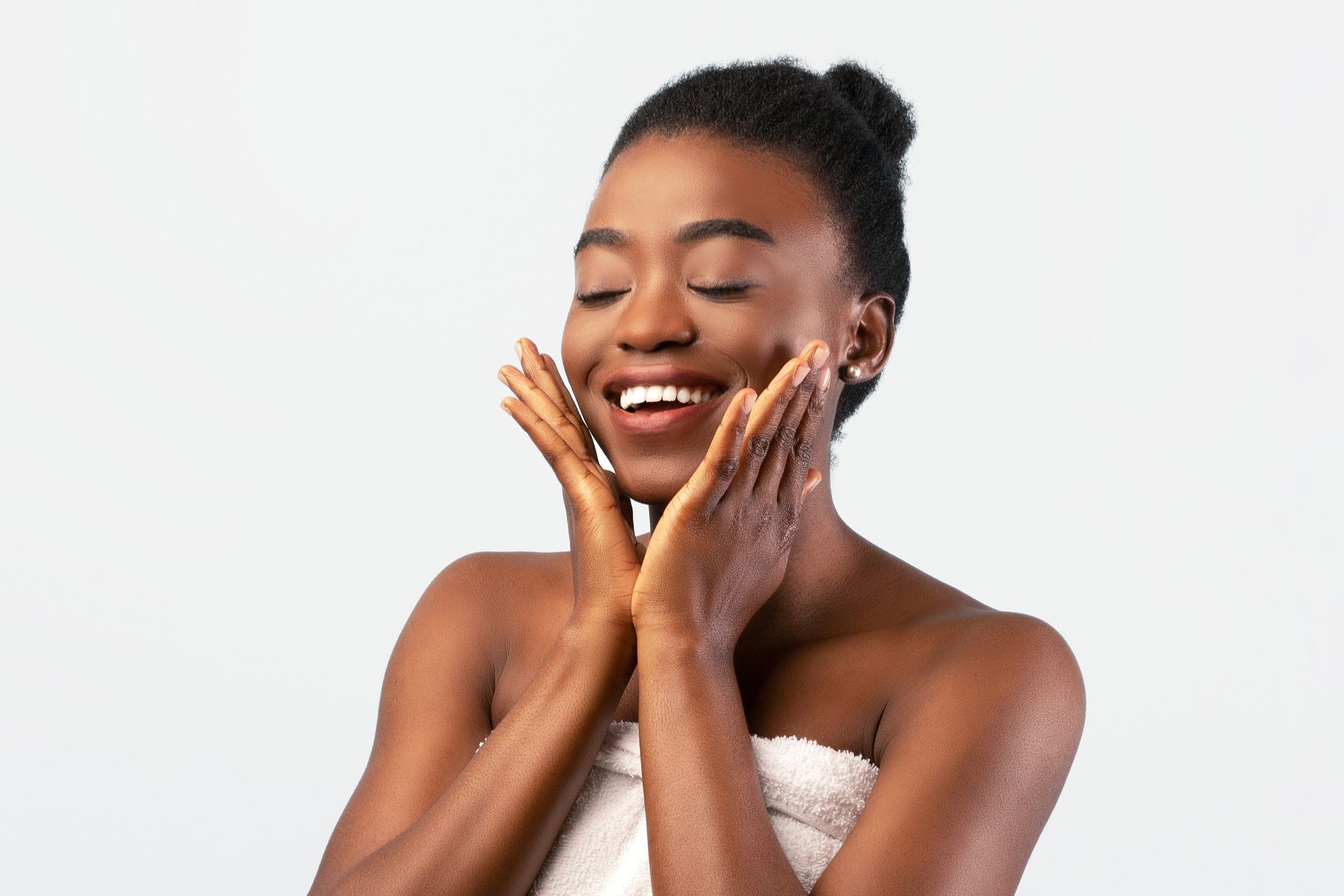 A woman headshot touching her face