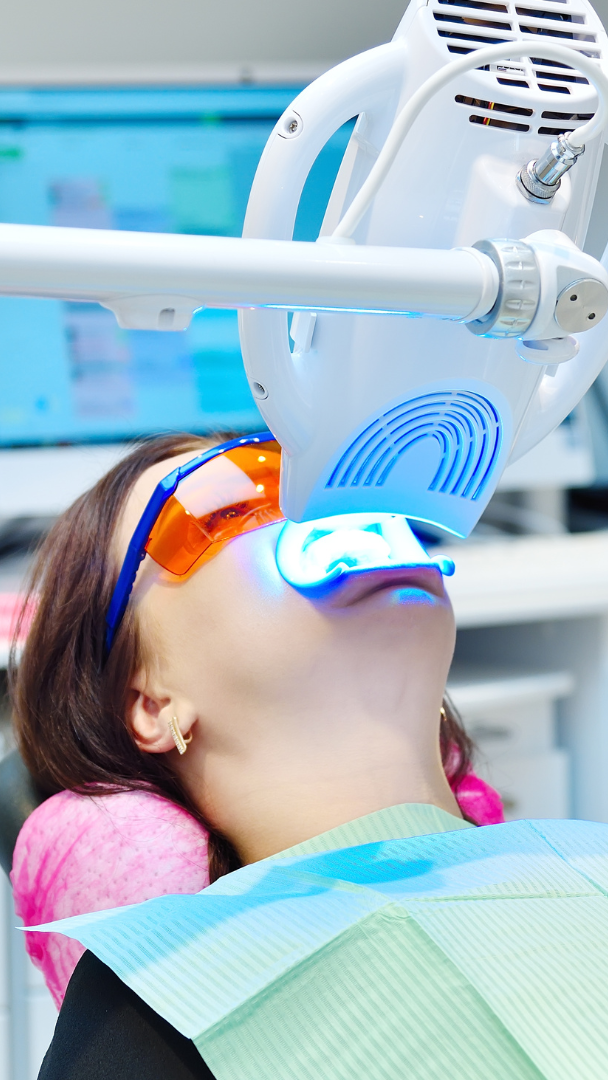 A woman is getting her teeth whitened at the diamond dental studio