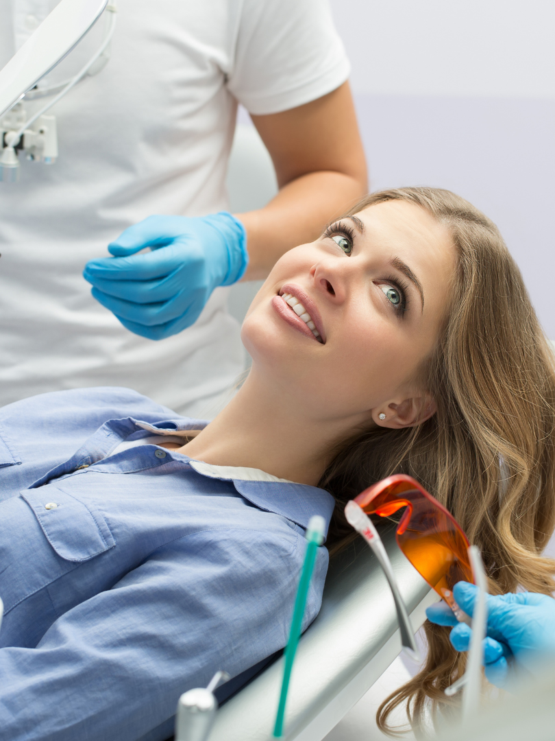 A woman is getting her teeth whitened at the diamond dental studio