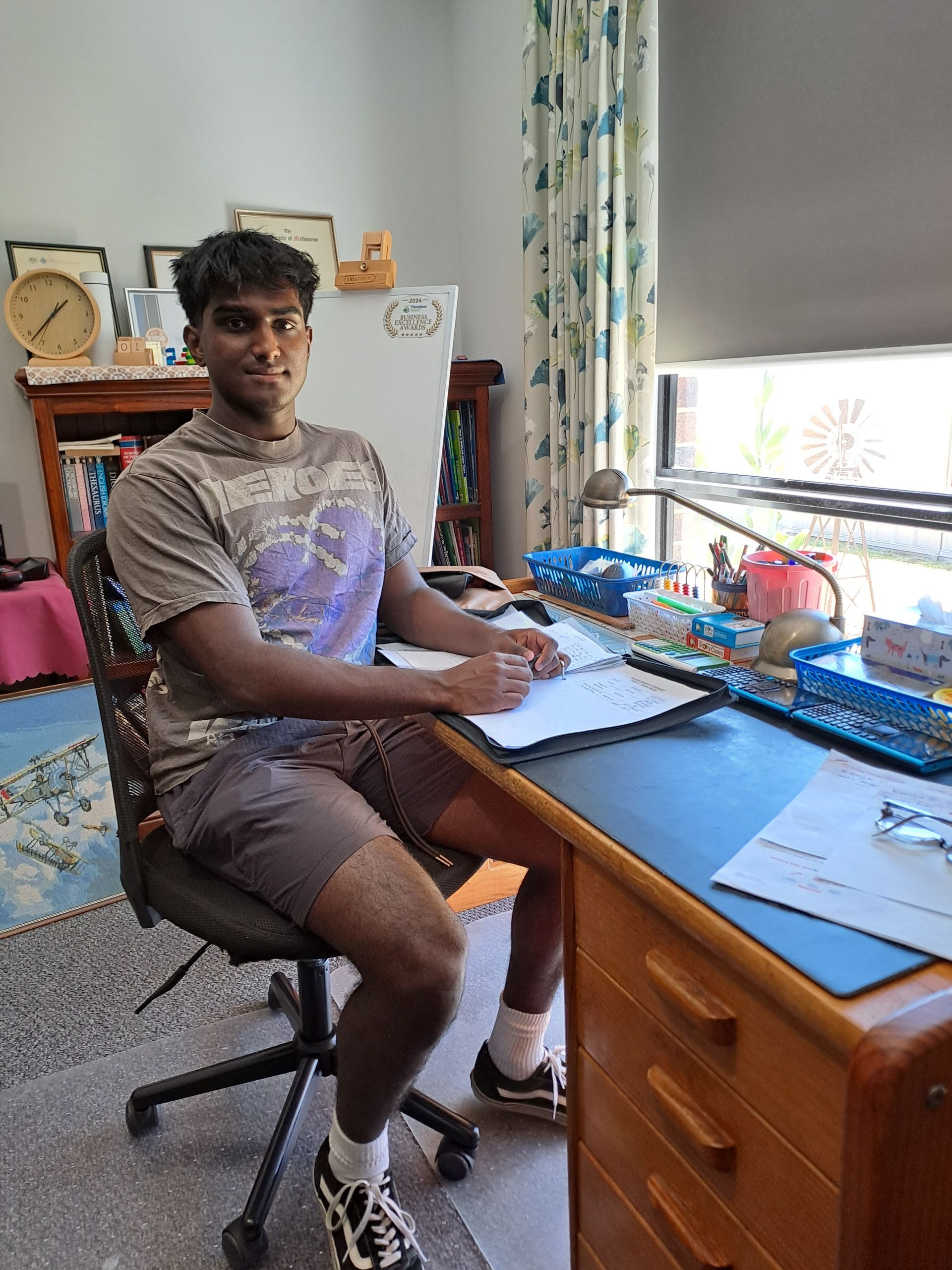 A man is helping another man with his homework.