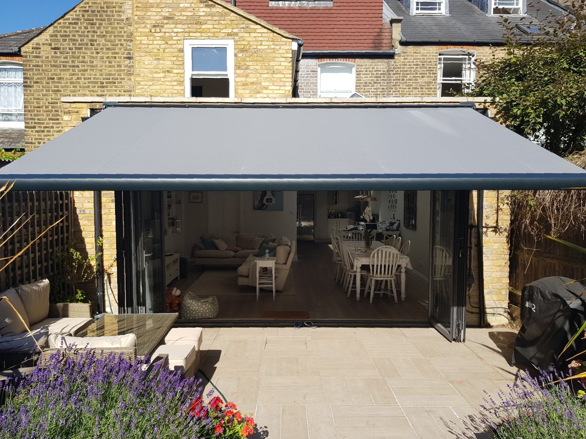 A close-up of a motorized retractable awning, showing the durable fabric and sleek design.