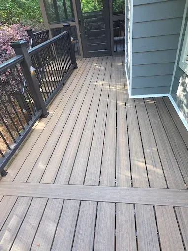 Composite deck with a dark railing and a screened porch.