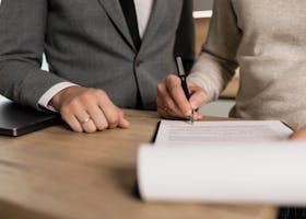 People signing a document