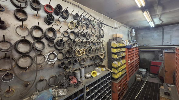 Workshop interior with parts organized on wall hooks and shelves.