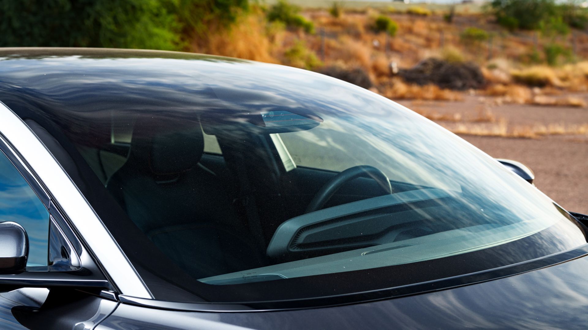 A close up of the windshield of a black car