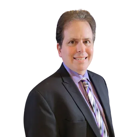 A person smiling while wearing a dark suit, purple collared shirt, and a striped tie against a white background.