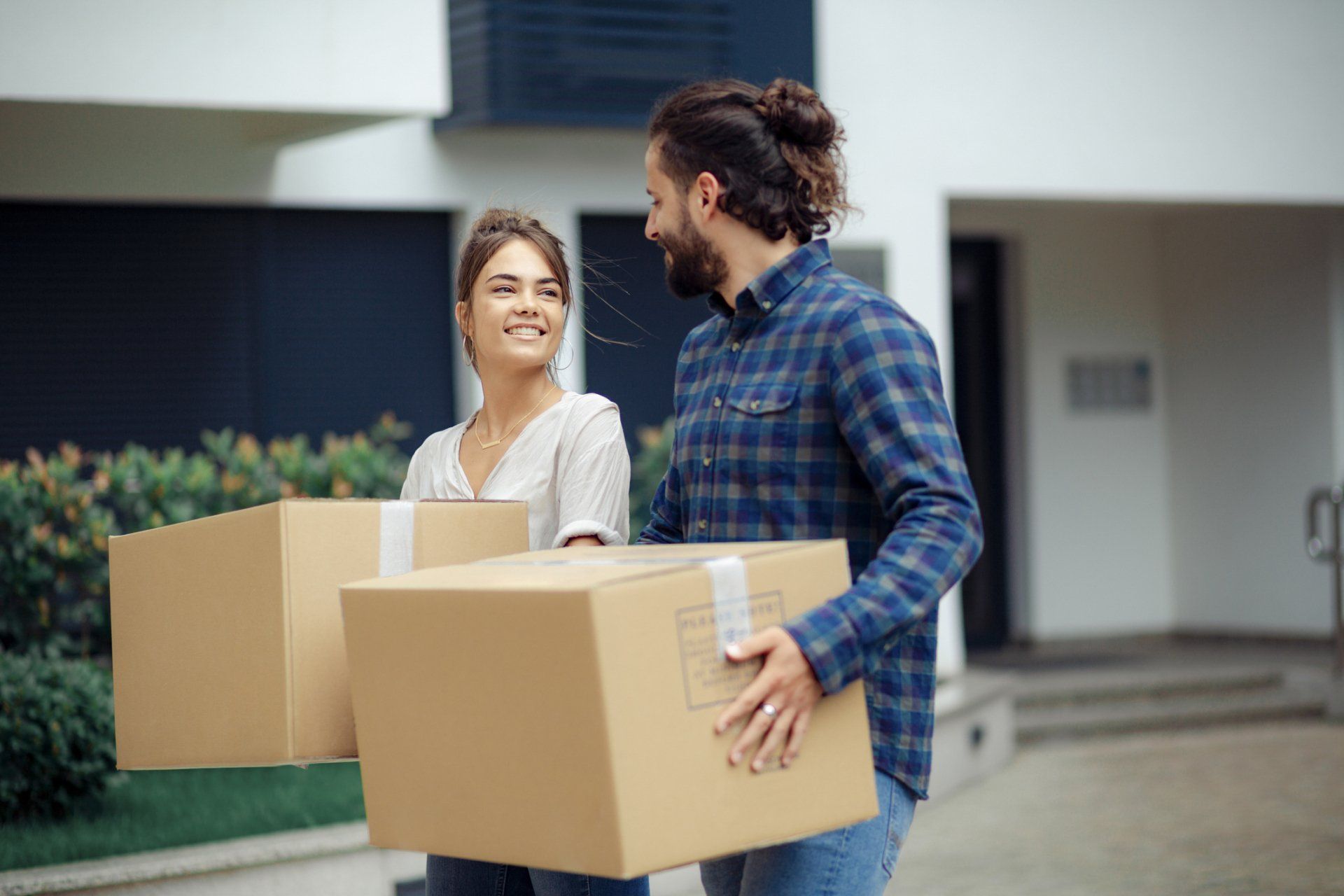 Couple moving their  stuff into their new place