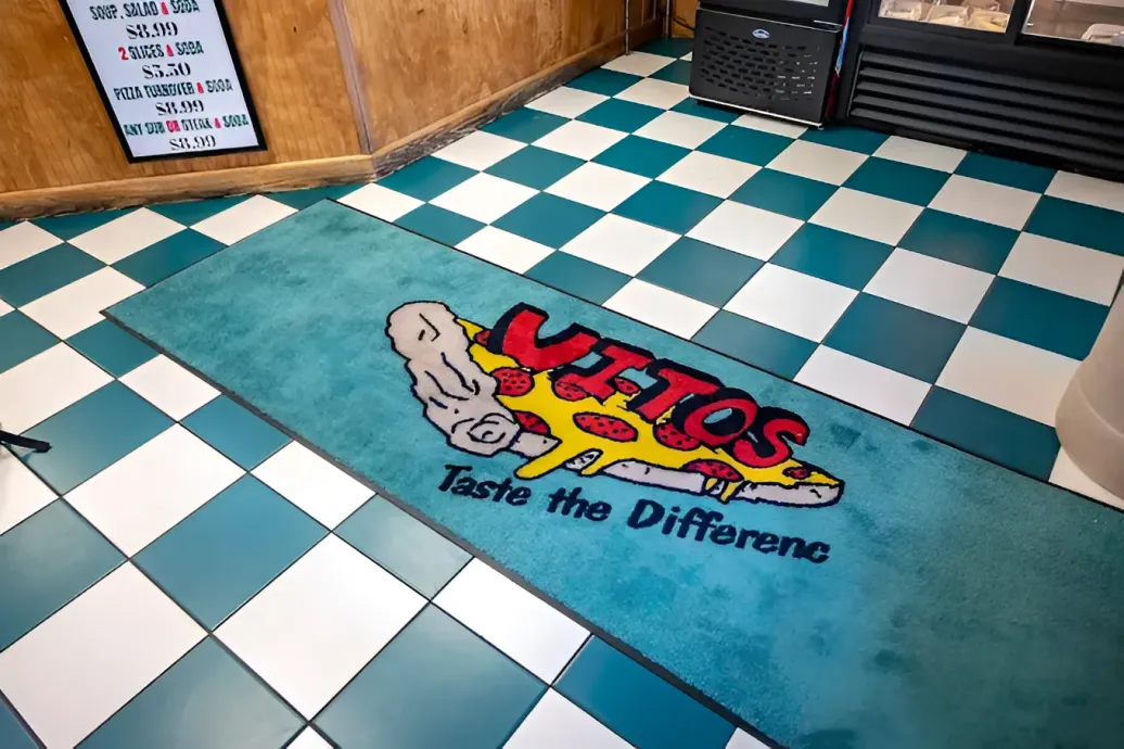 A teal floor mat with 