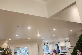 Clean, patterned carpet in a room with a bed and dresser. The pattern is geometric with pointed triangles.