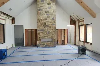 Clean, patterned carpet in a room with a bed and dresser. The pattern is geometric with pointed triangles.