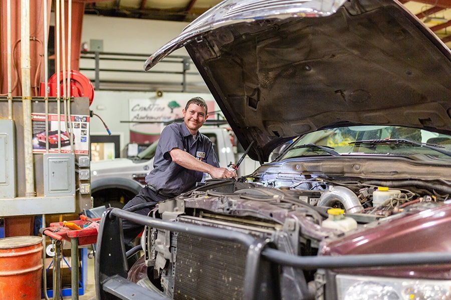 Mechanic Checks Vehicle Engine | Crabtree Automotive