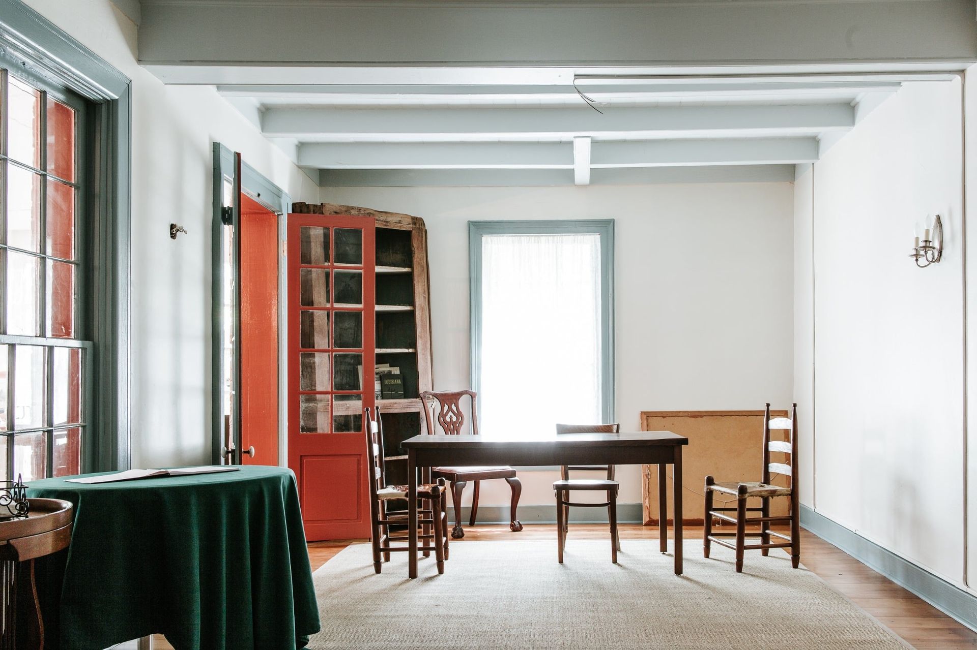 A room with a table and chairs in it