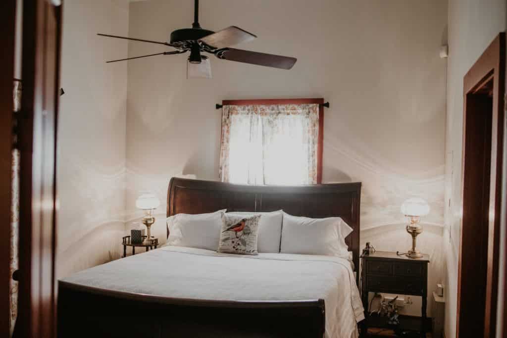 There is a ceiling fan above the bed in the bedroom.