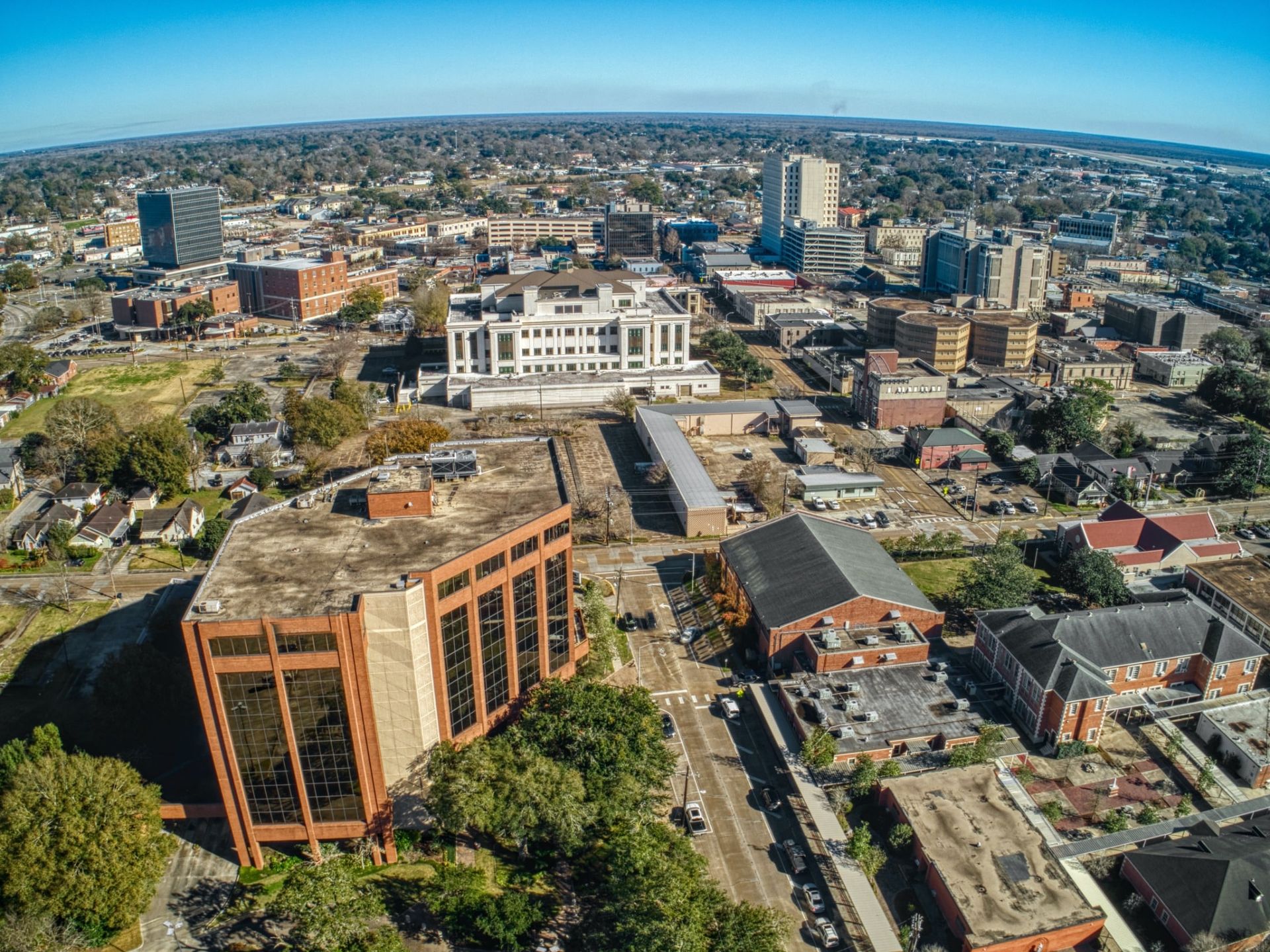 An aerial view of a city with lots of buildings and trees.