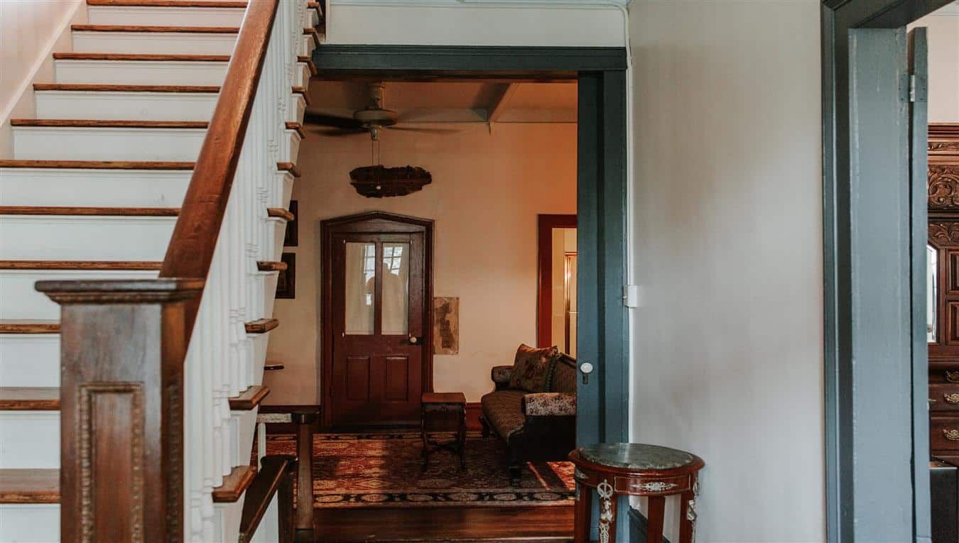 A staircase leading up to a living room in a house.