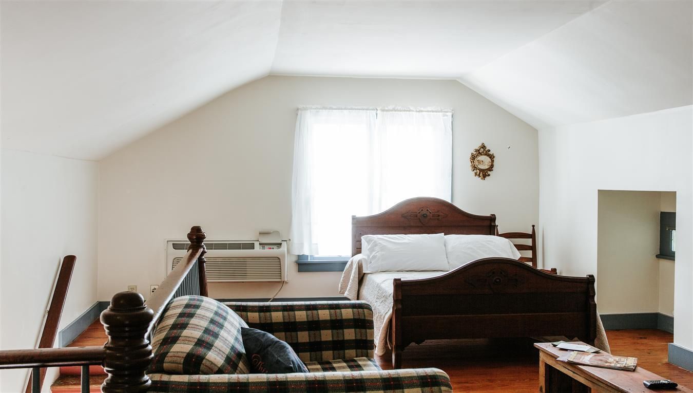 A bedroom with a couch and a bed in it