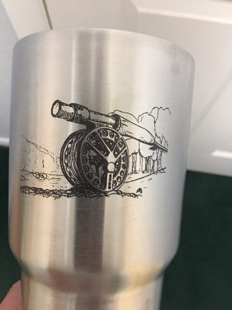 Brushed metal tumbler with black cannon illustration on the side