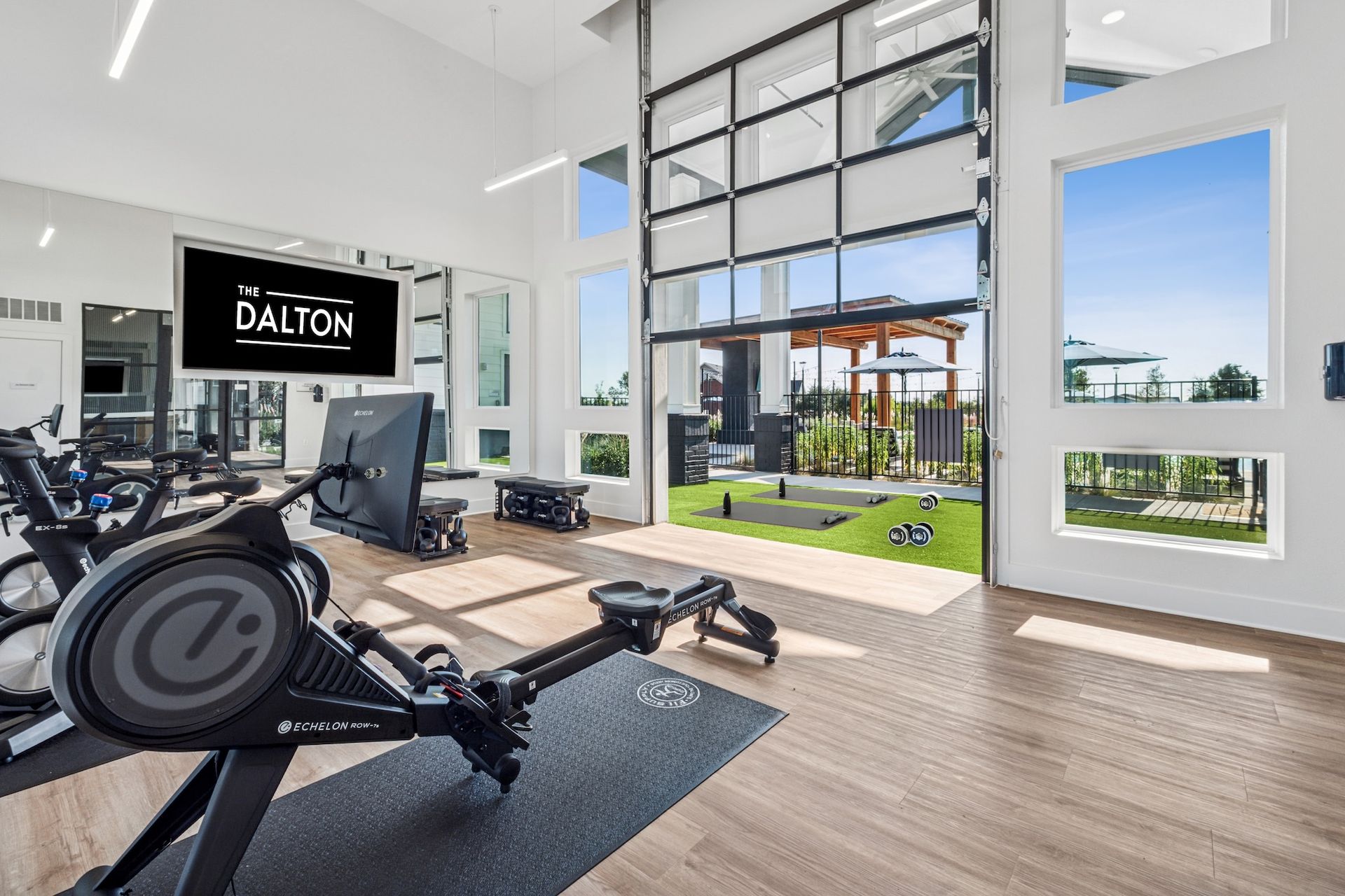 Gym at The Dalton with rowing machine and outdoor view.