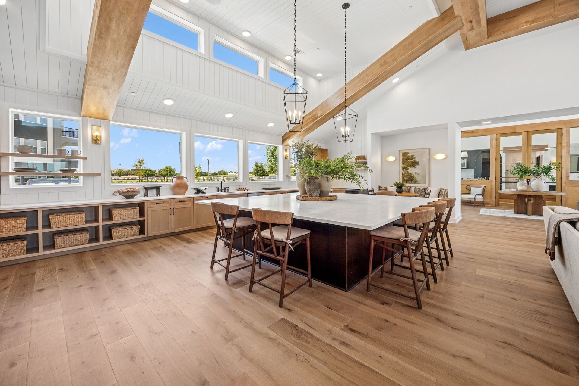 A large kitchen with a large island and a lot of windows.